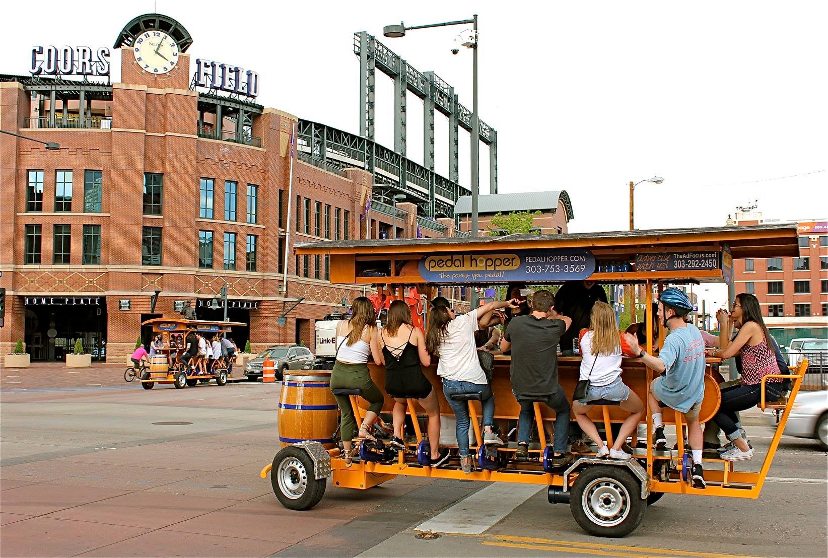A Pedal Hopper tour group outside Coors Field in downtown Denver 