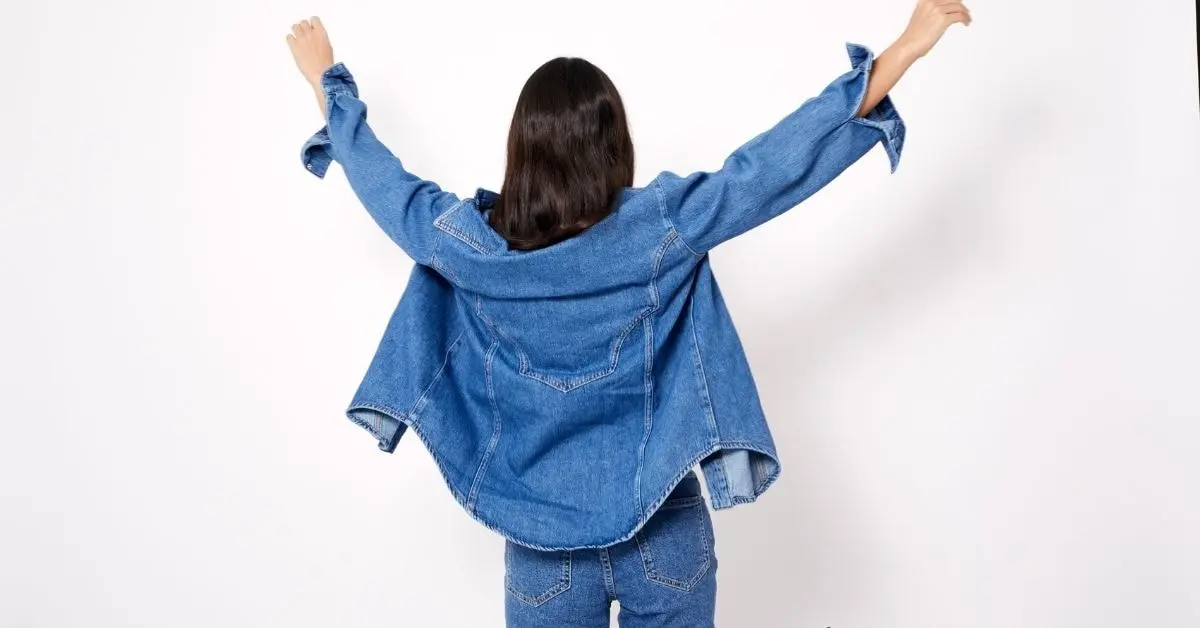 A confident OnlyFans creator showcasing her denim outfit, representing the importance of sales tax compliance in managing her income.