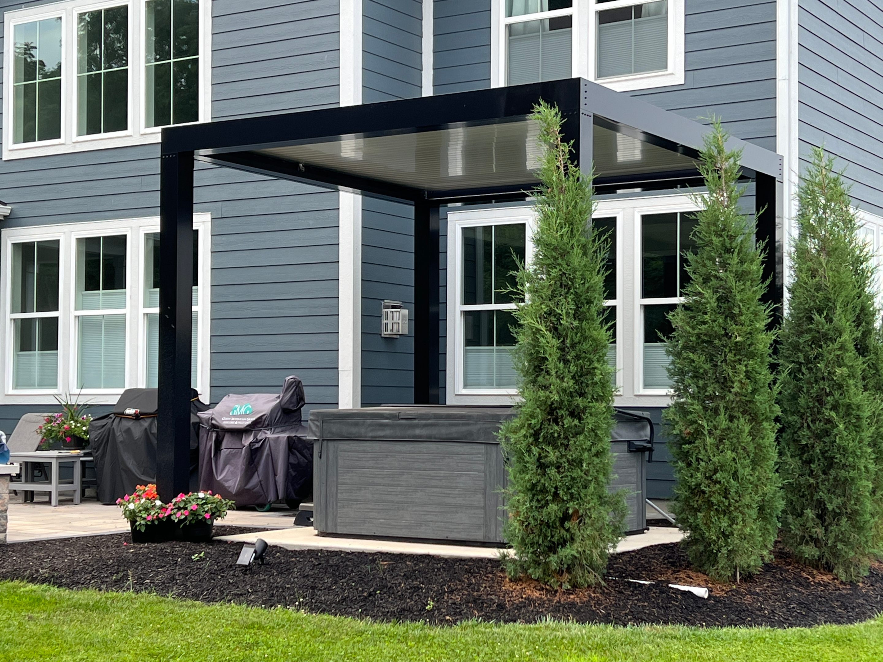 louvered roof with hot tub in backyard