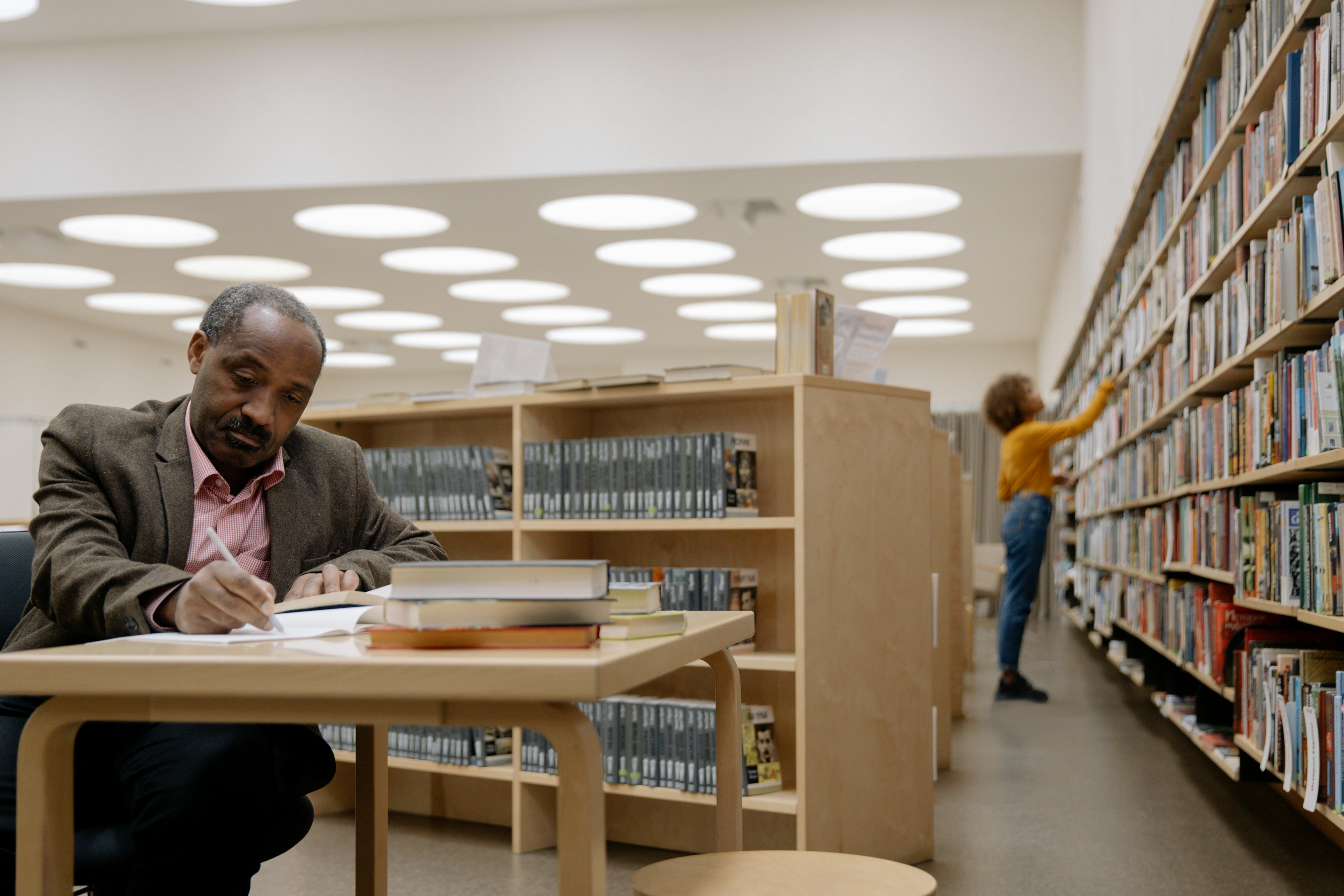 Real estate investor at public library gathering various archived property records.