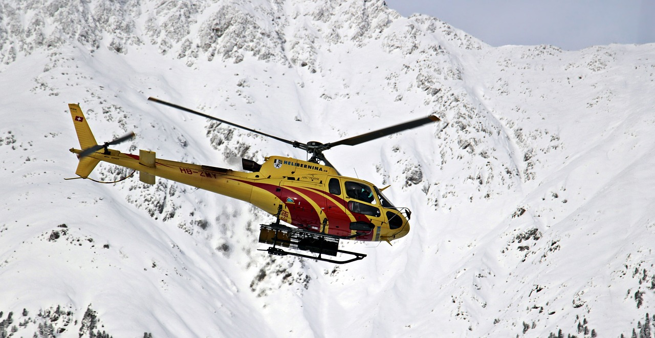Rescue helicopter flying through a mountain range.