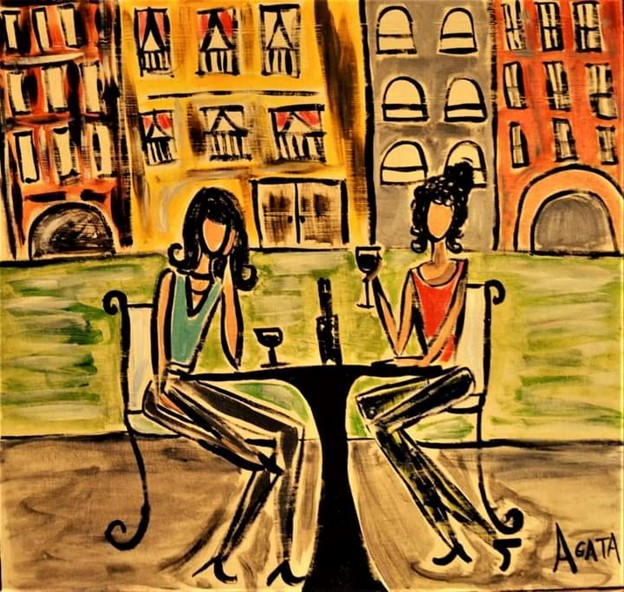 two women at table enjoying wine 