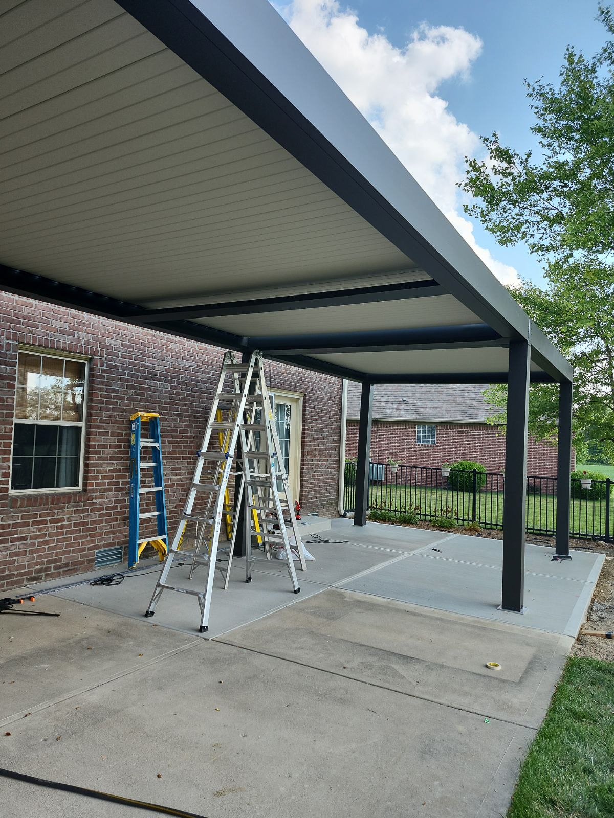 Contractor installing a pergola on support concrete pad poured to size for the pergola. Construction to form to your desire is sometimes necesary with the provided materials.