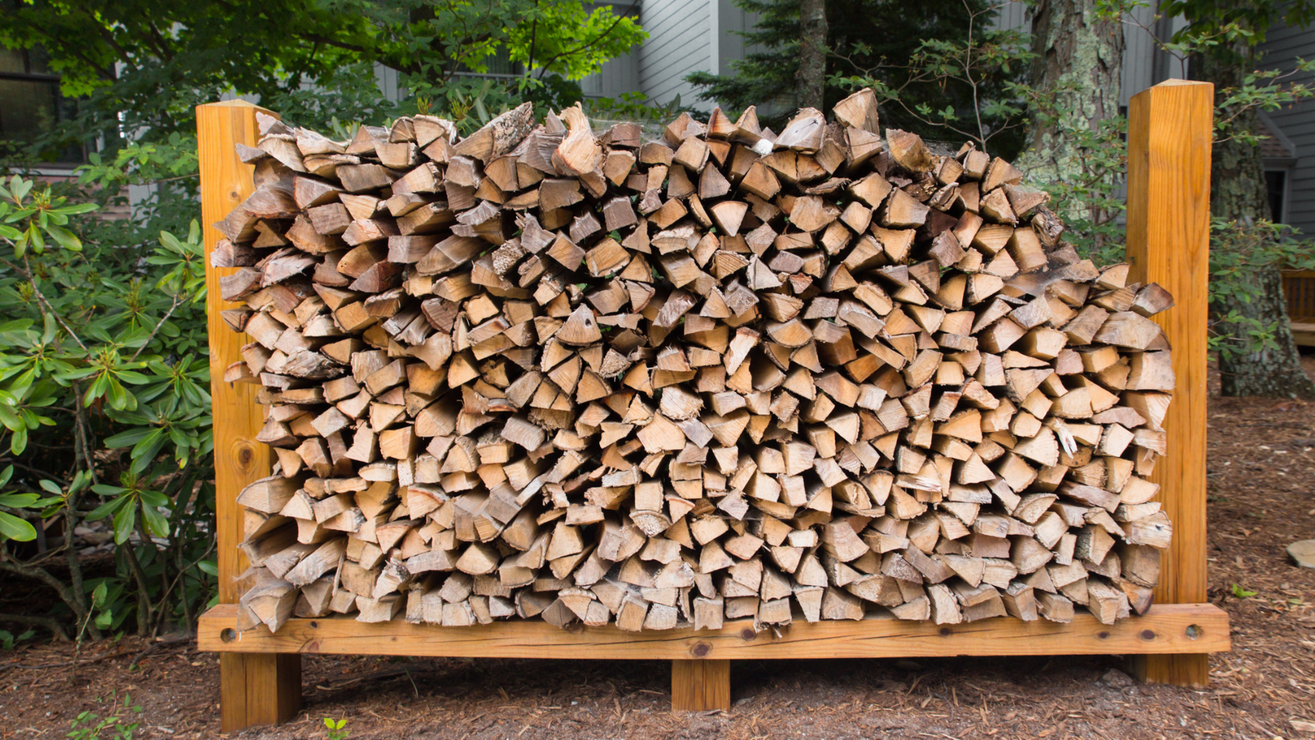 A stack of firewood in a firewood shed. 