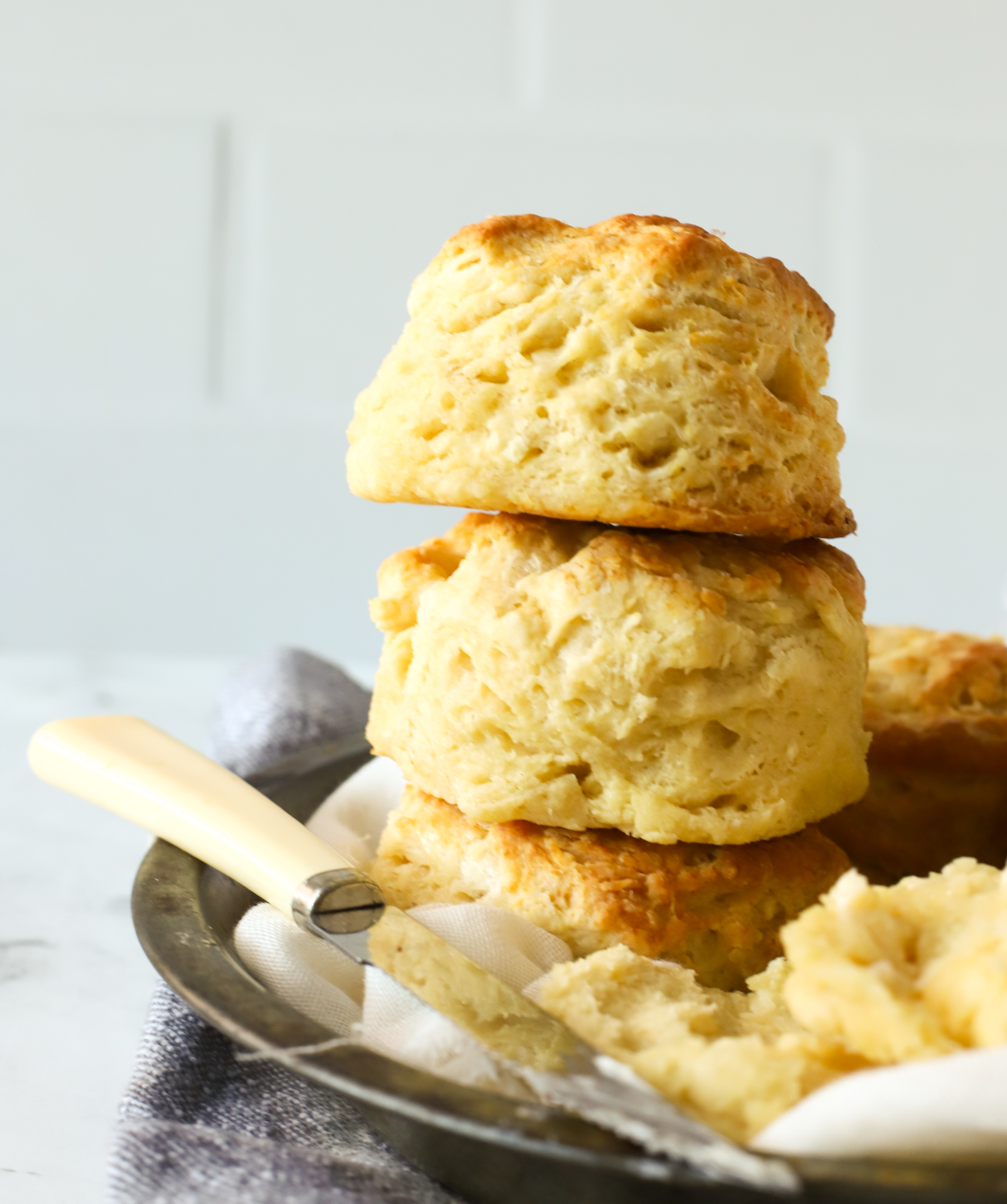 three buttermilk biscuits stacked on top of each other