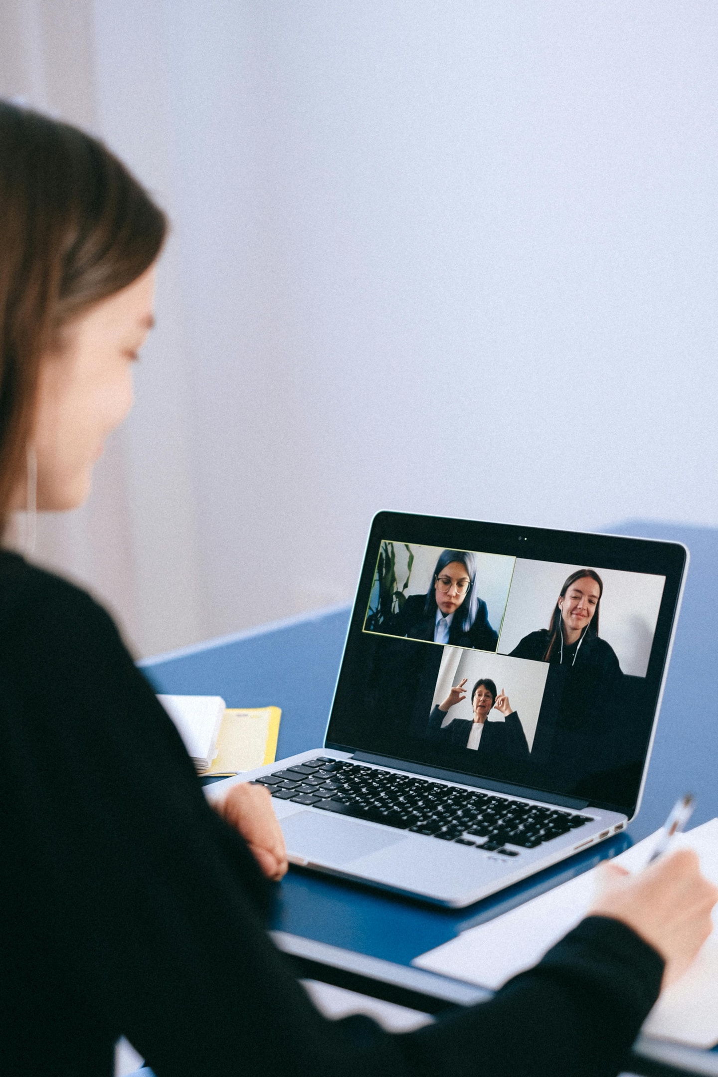 Real estate investor meets virtually with her team who help manage her properties in another state.
