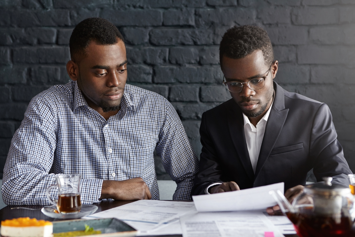 Two men looking at finances