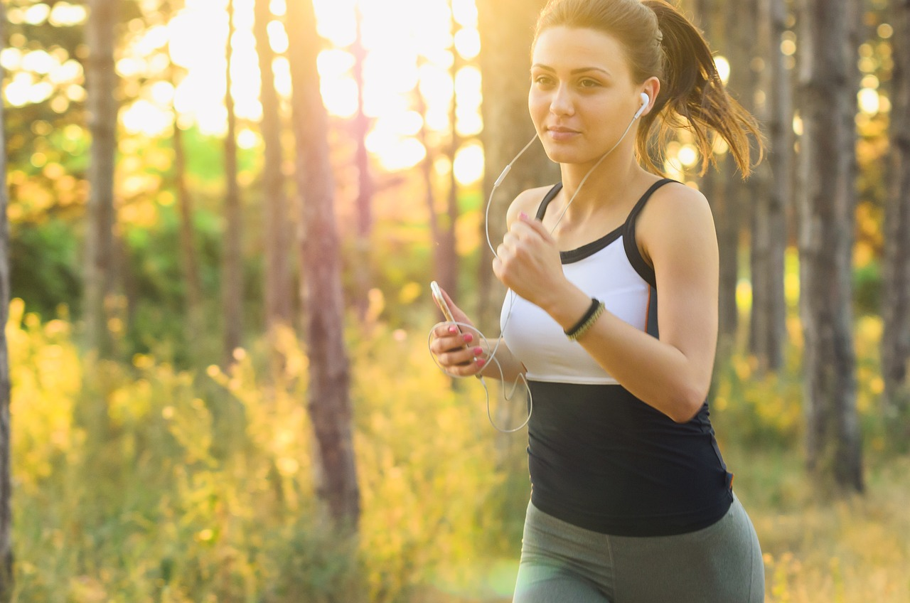 An image of a young woman jogging outside. 