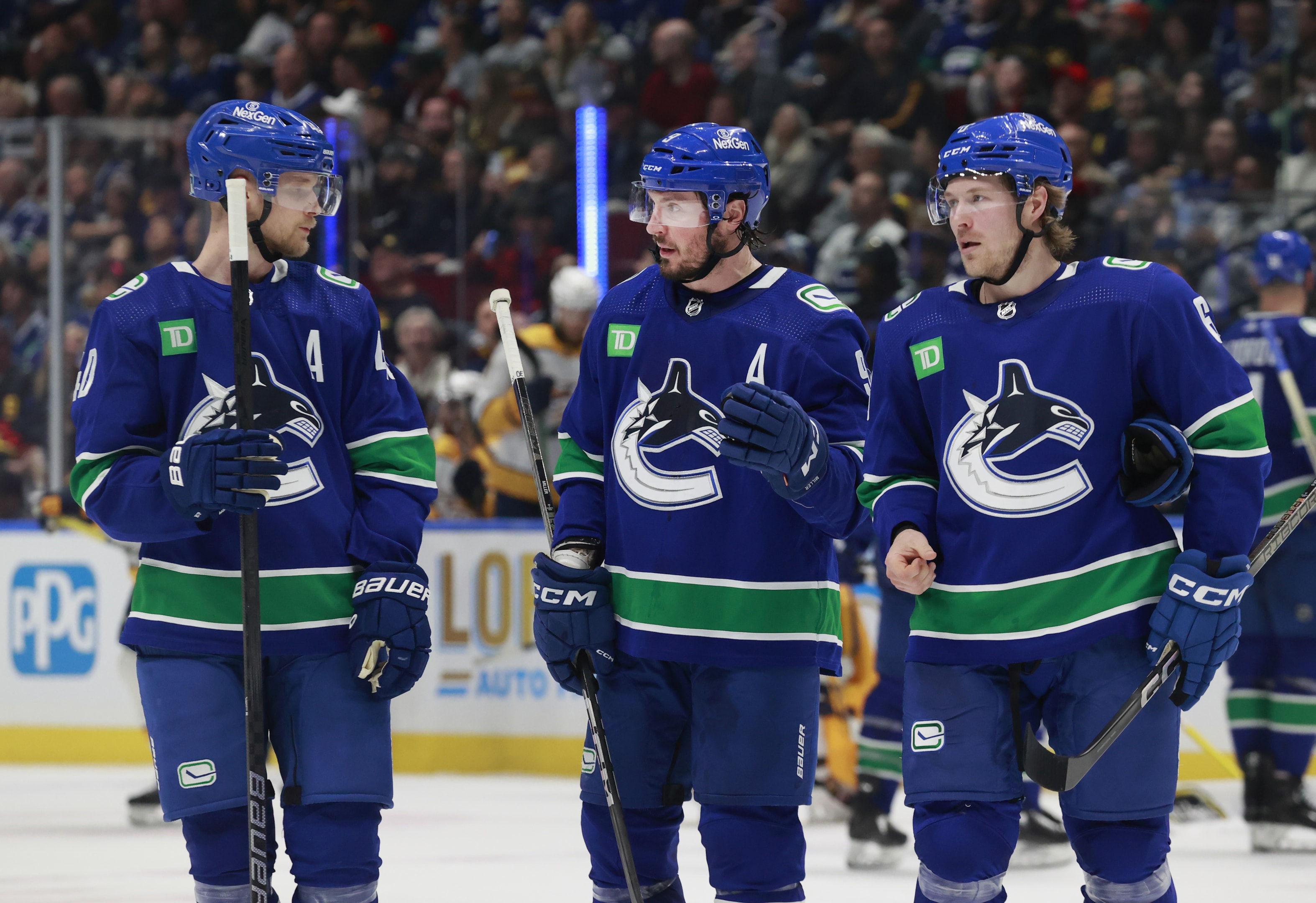 J.T. Miller of the Vancouver Canucks talks to teammates Elias Pettersson and Brock Boeser during Game Five of the First Round of the 2024 Stanley Cup Playoffs on April 30, 2024 in Vancouver, British Columbia, Canada. 