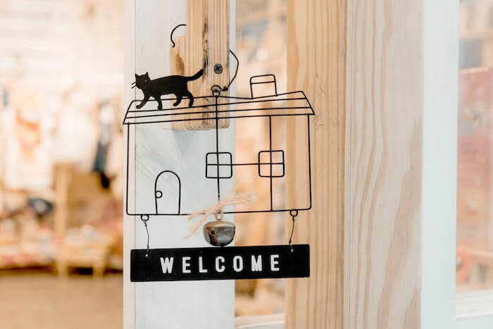 Airbnb welcome book wall hanging with cat