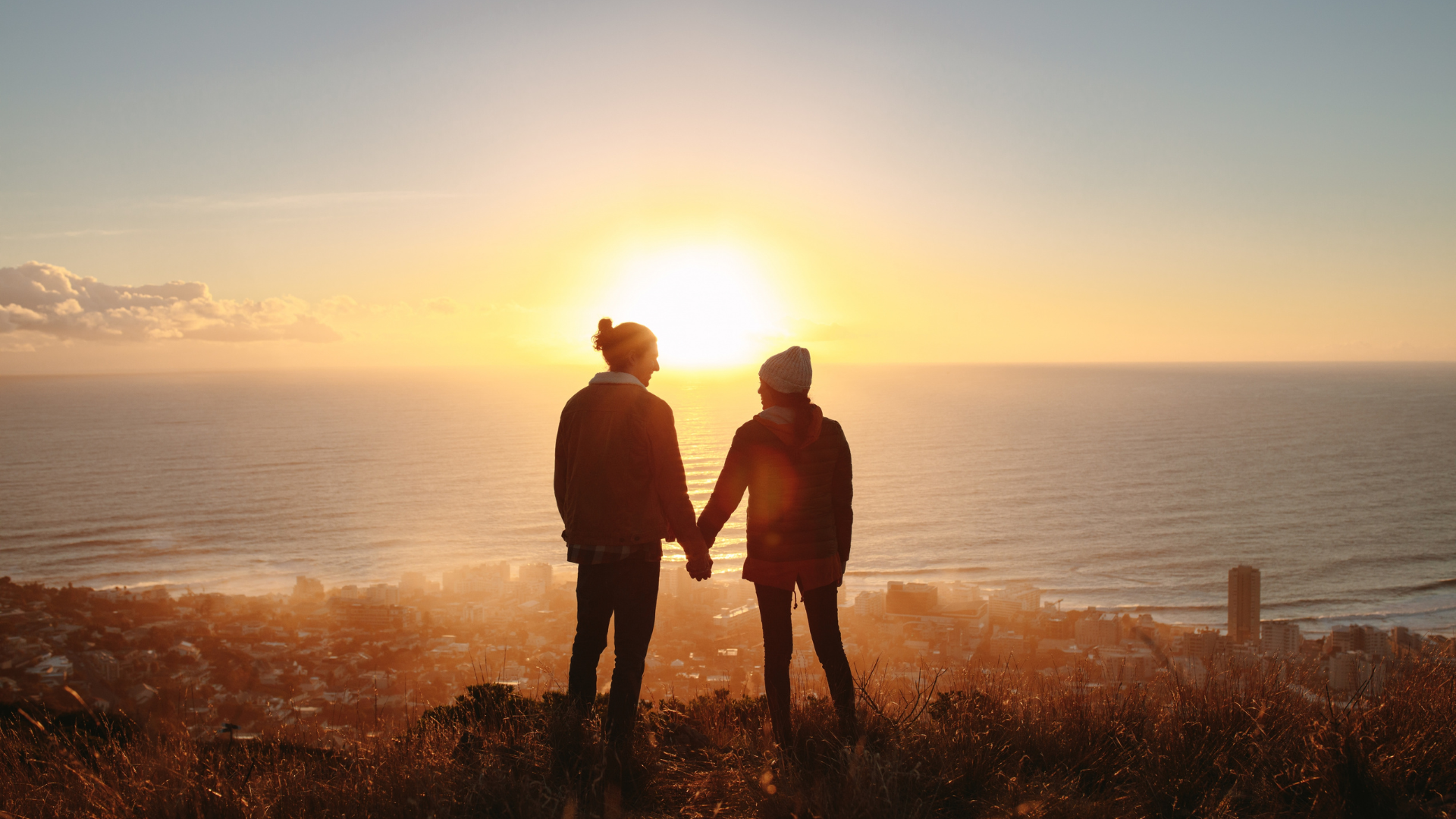 Couple standing in front of sunset