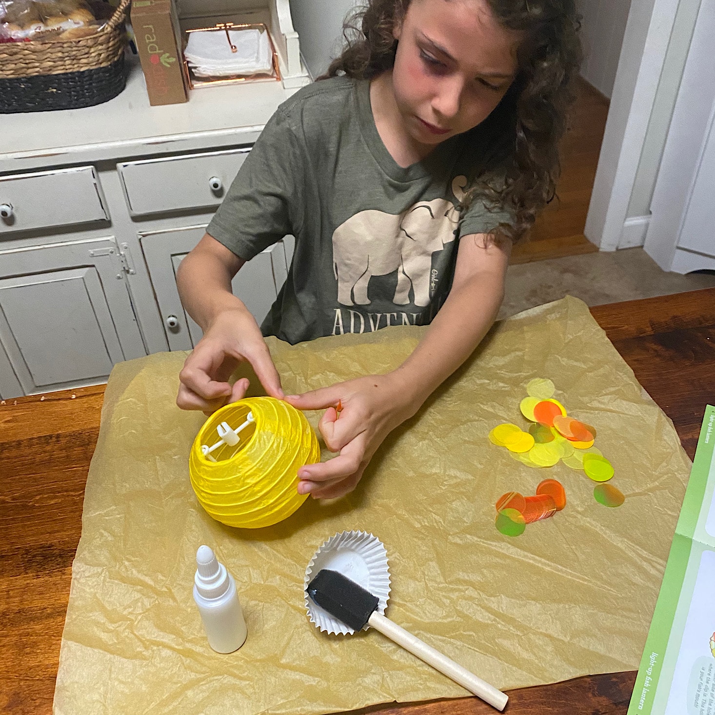 Brandi's daughter working on a craft from her KiwiCo crate.