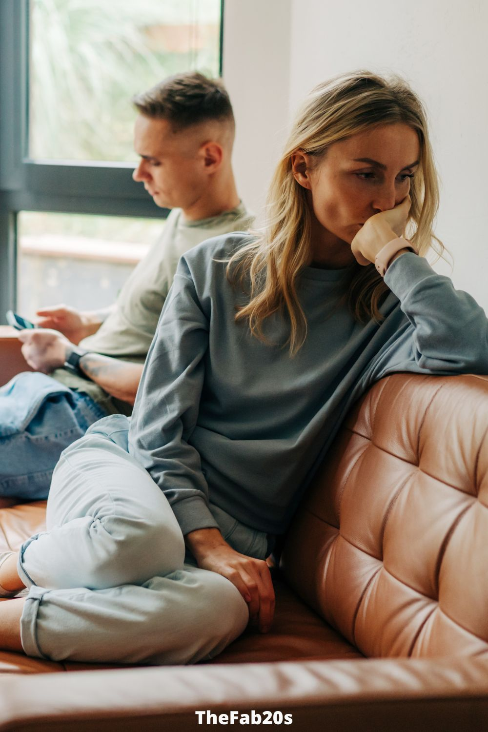 woman  thinking hard while boyfriend ignores her - Featured In How To Stop Overthinking In A Relationship 