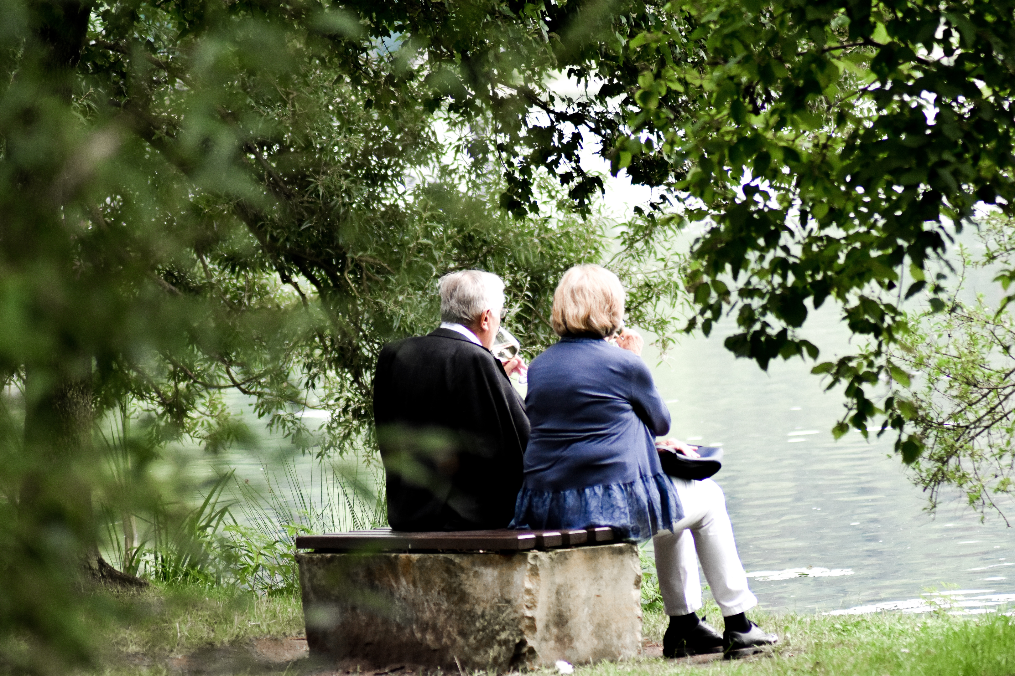 Senior couple sitting together overlooking a lake