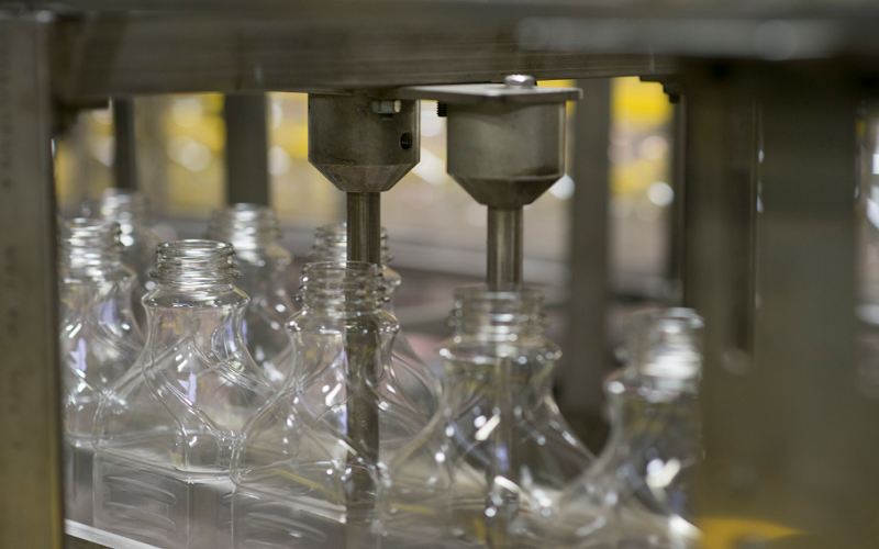 blow molded plastic bottles and containers produced on a high-volume manufacturing production line