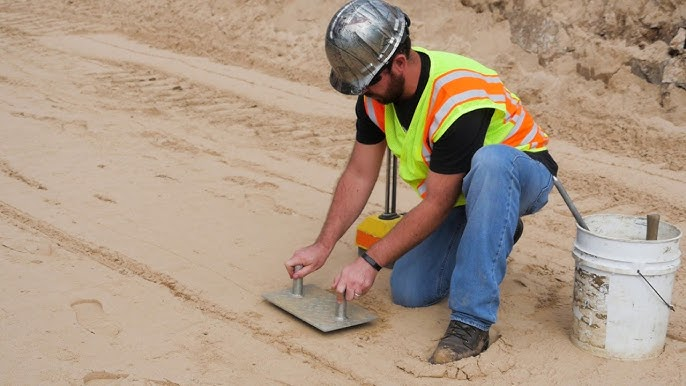 A technician performing field and laboratory testing on construction materials