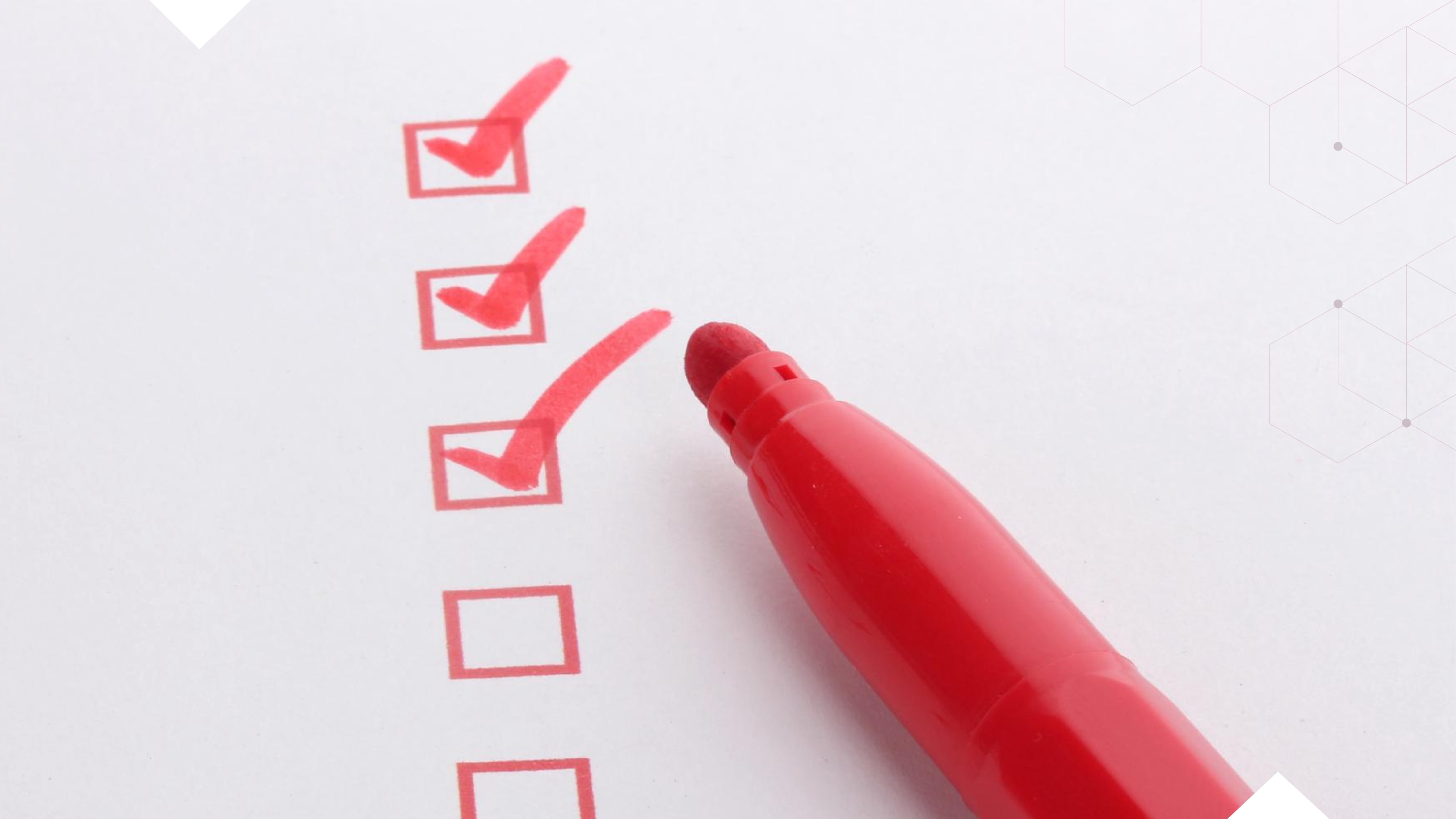 Close-up of a red marker next to a checklist with several red checkmarks, symbolizing key features or benefits of hosted phone systems.