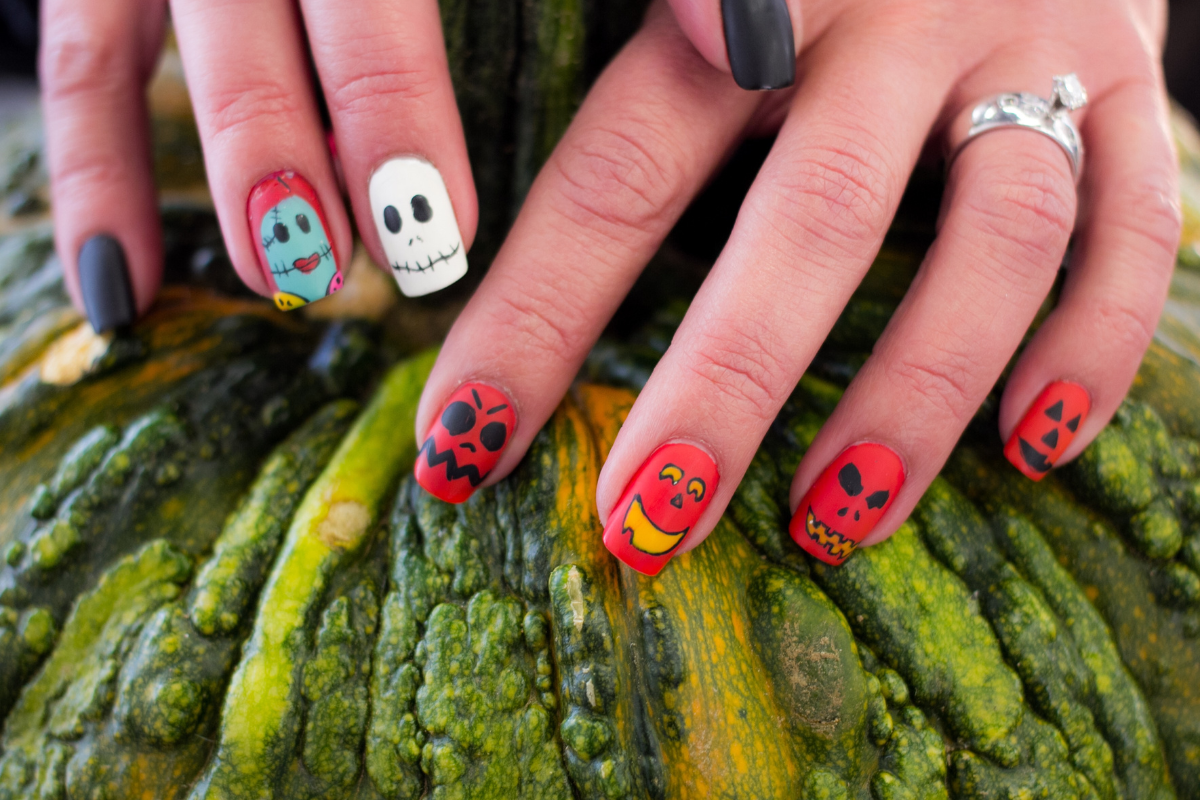 A vibrant illustration of jack-o'-lantern nail designs.