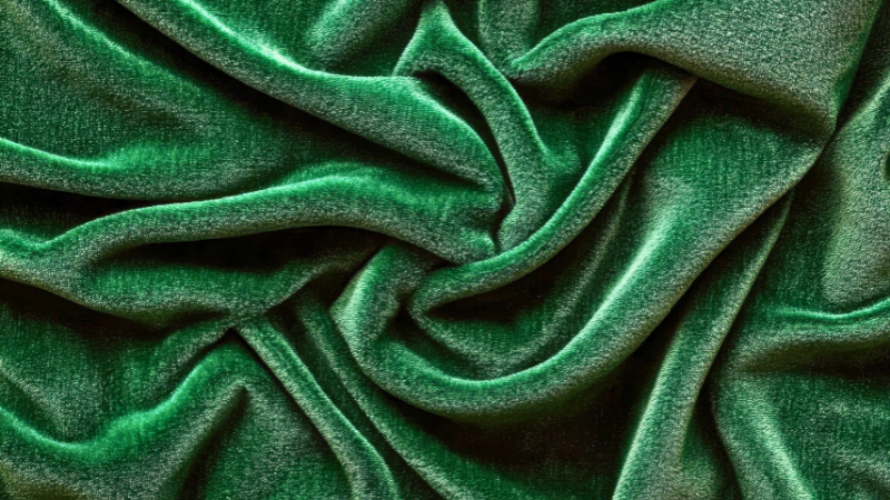 A close up image of a green velvet fabric
