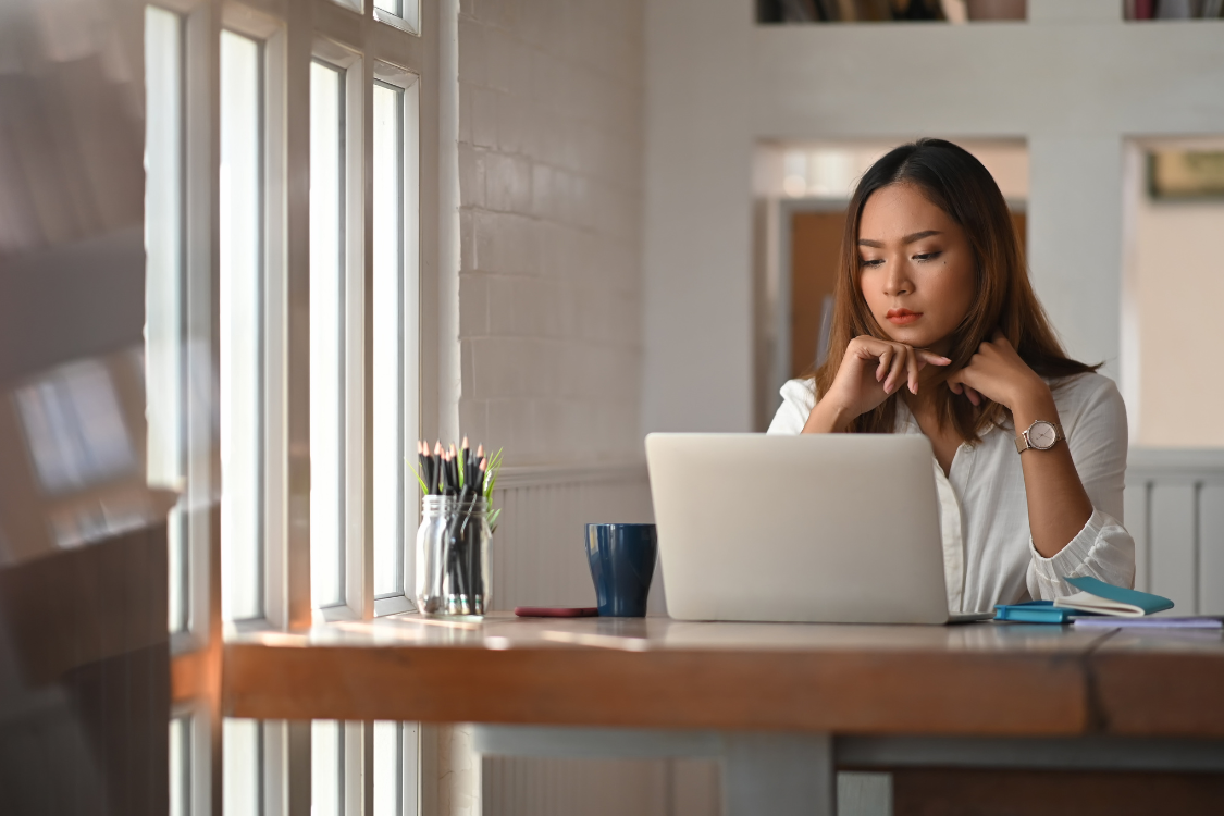 Filipino virtual assistant focused on completing skills test at home desk