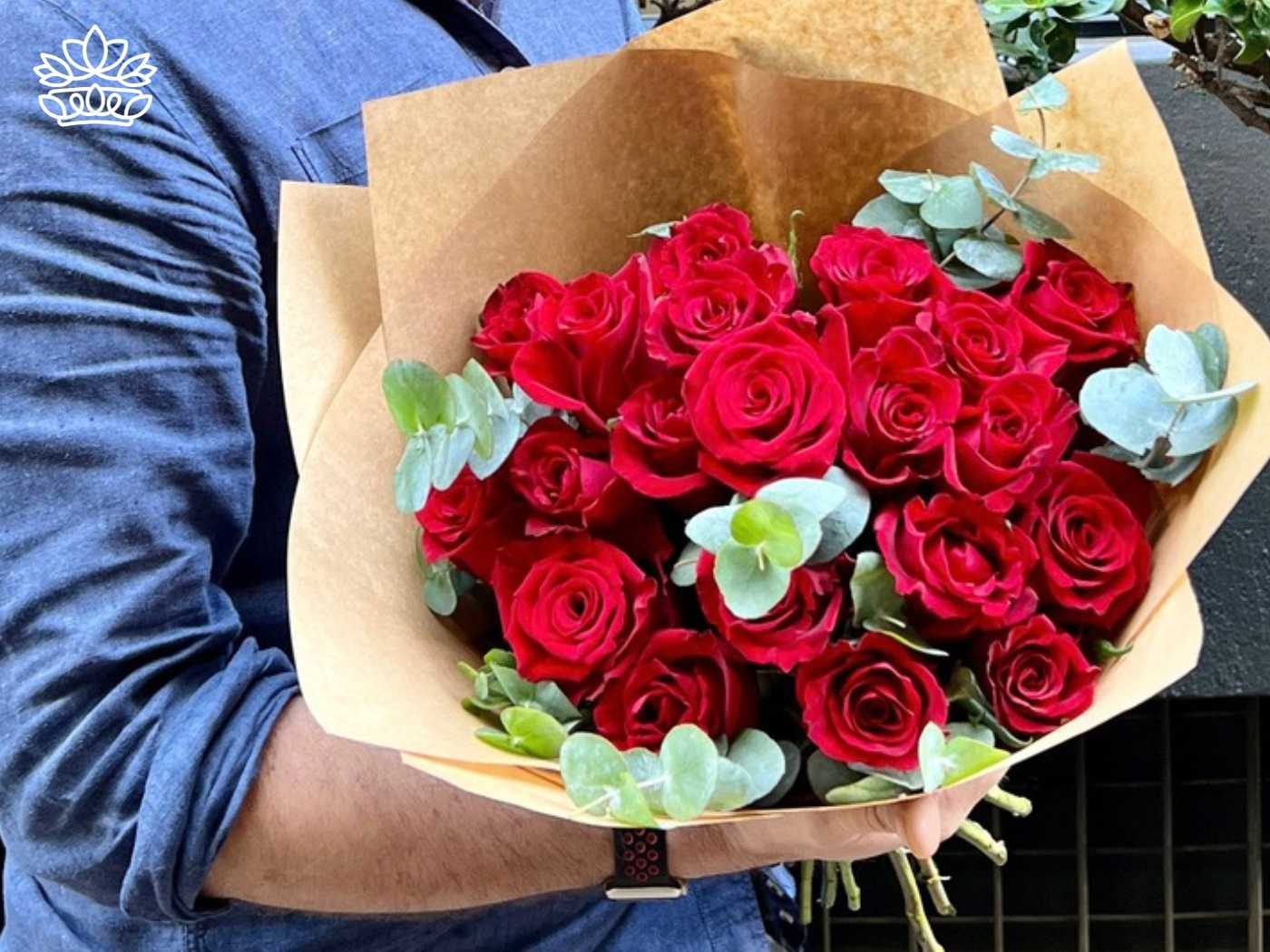 Stunning bouquet of red roses from the Flowers By Type Collection, with eucalyptus leaves, representing the genus Rosa at Fabulous Flowers and Gifts. Cut flowers appear ready to germinate and act as the perfect gift.