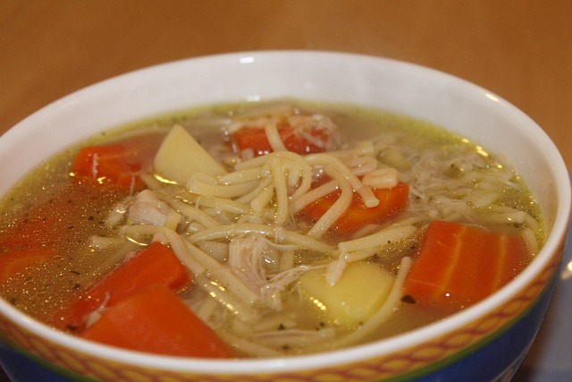 An image of a bowl of chicken noodle soup, a food for sore throat.