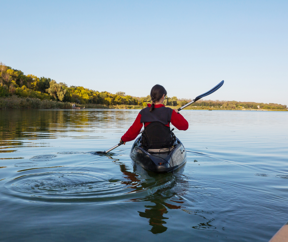 Woman in a boat kayaking down a river