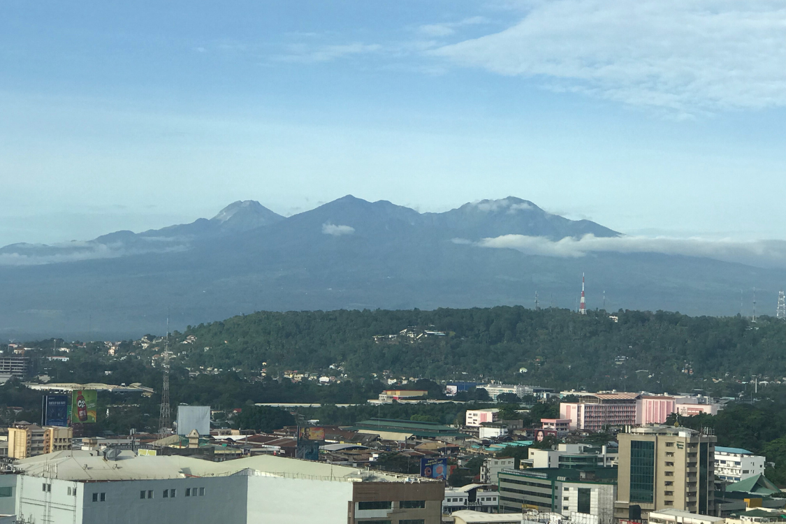 Panoramic view of Davao City with Mount Apo in the background, showcasing the natural beauty and growing urban landscape.