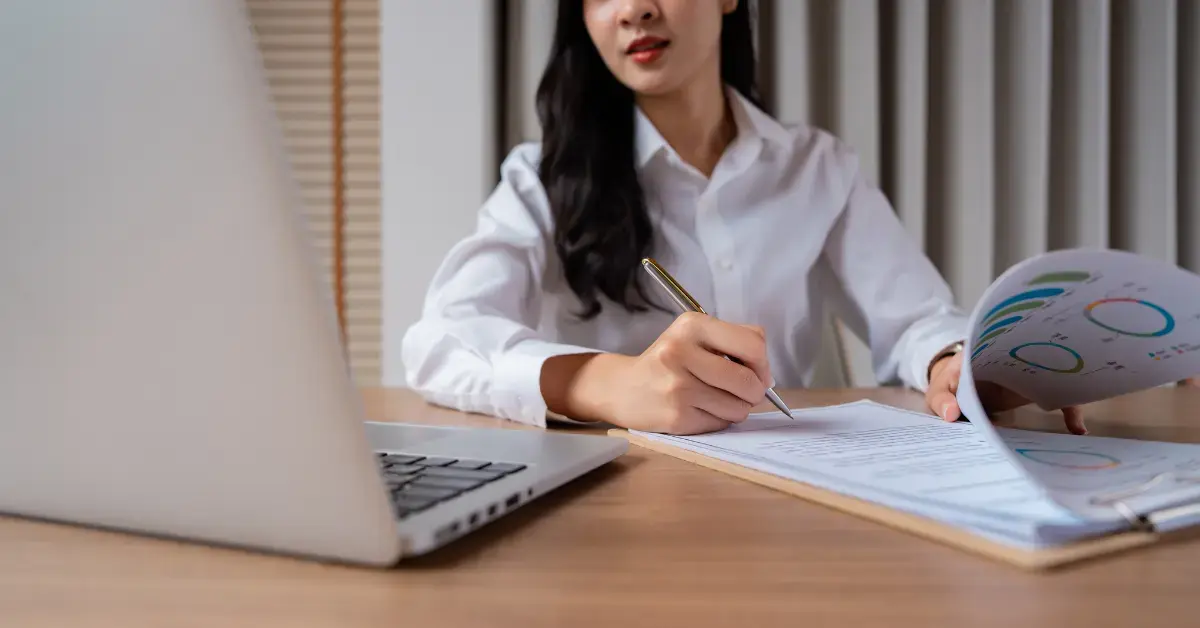 Woman preparing a CP59 notice response with Form 15103 and tax filing records.