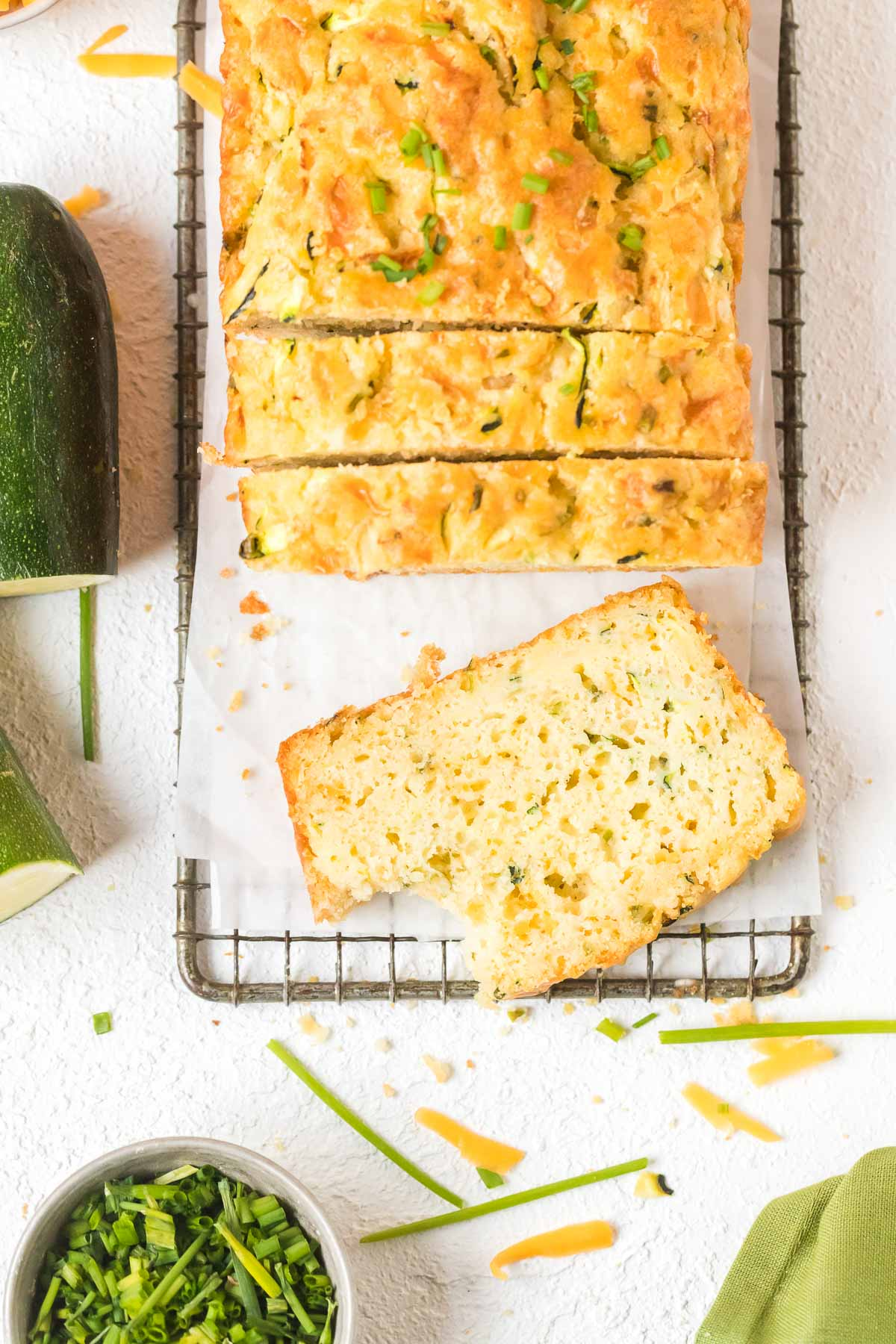 slice of zucchini cheddar bread with bite taken out of it