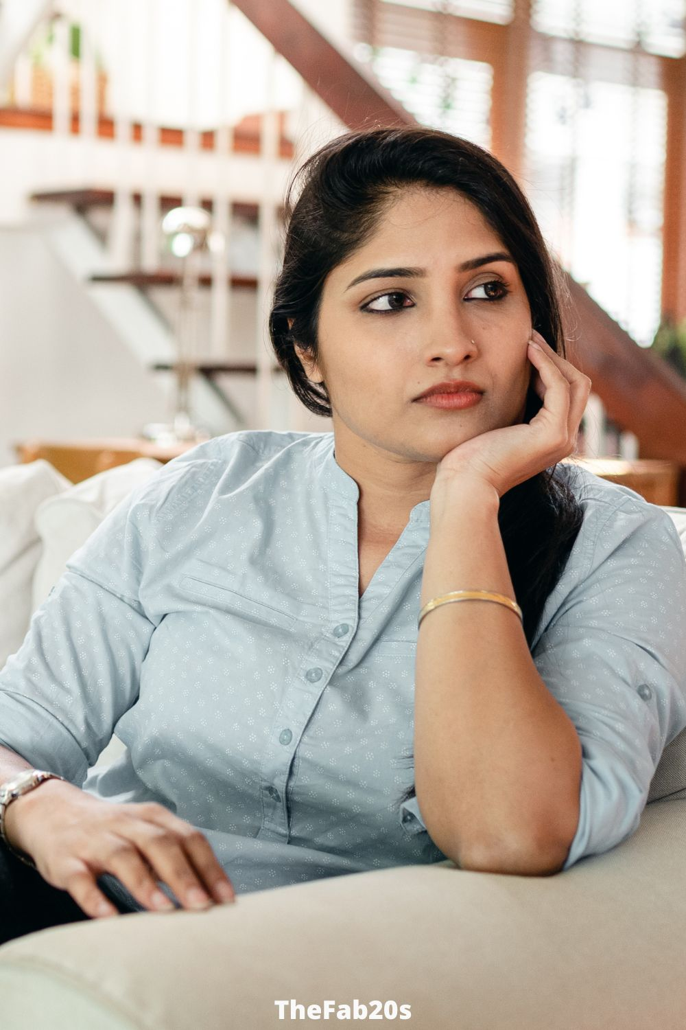 Woman looking off in the distance, deep in thought.