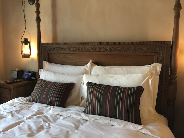 wood bed with king pillows