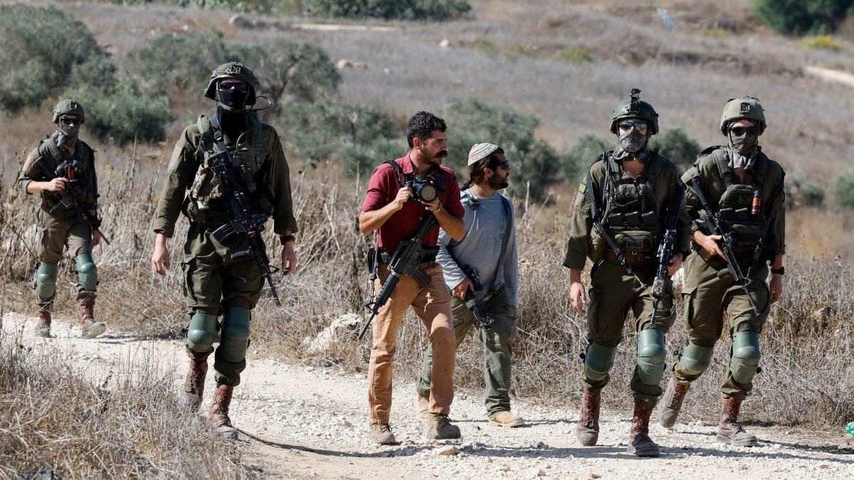 Israeli settlers and soldiers prevent Palestinians and foreign activists from accessing olive trees during olive harvest, in the village of Tell, near Nablus, in the Israeli-occupied West Bank, Oct. 20, 2025. (Reuters Photo)