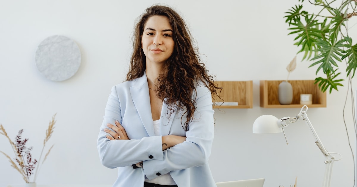 Confident professional woman in a light blue blazer, representing expertise in accounting and tax.