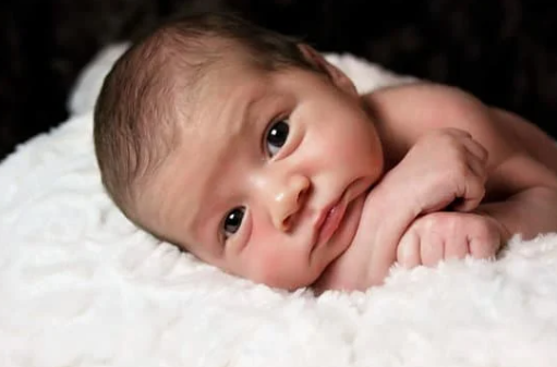 Baby posing for professional photograph whilst awake