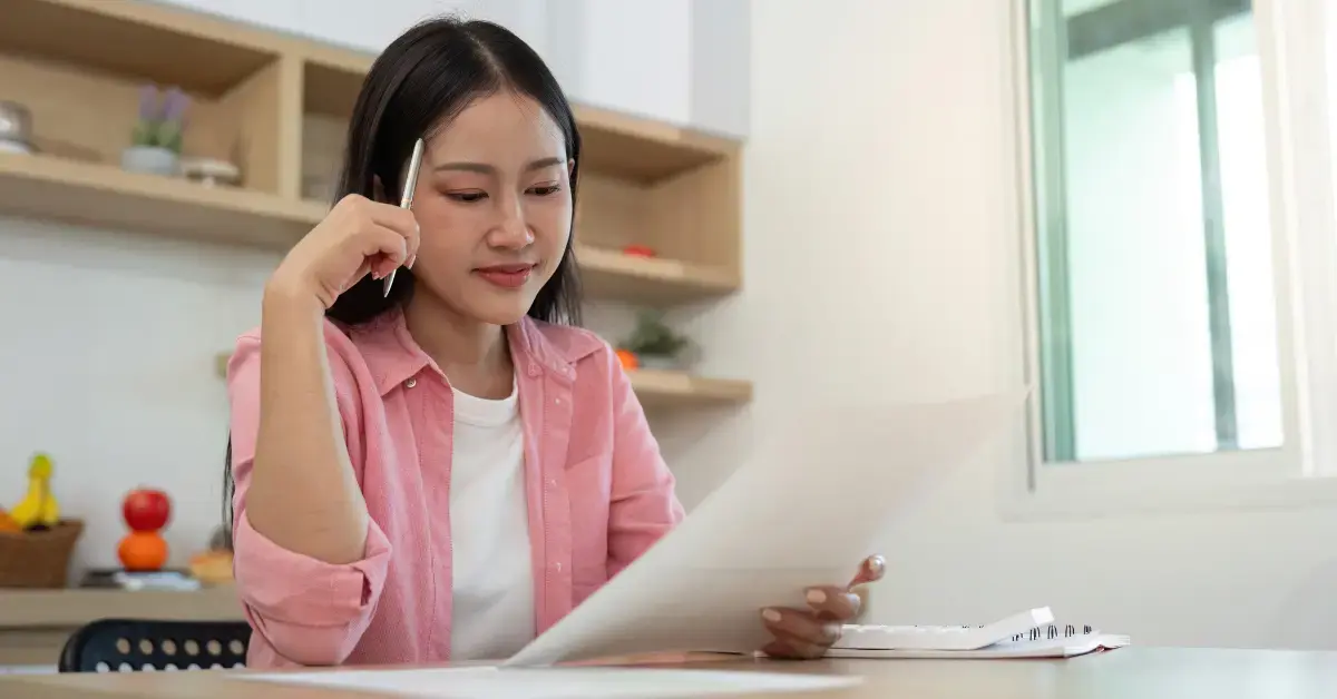 Woman reviewing retirement account documents and 5329 tax form for early withdrawal tax planning.
