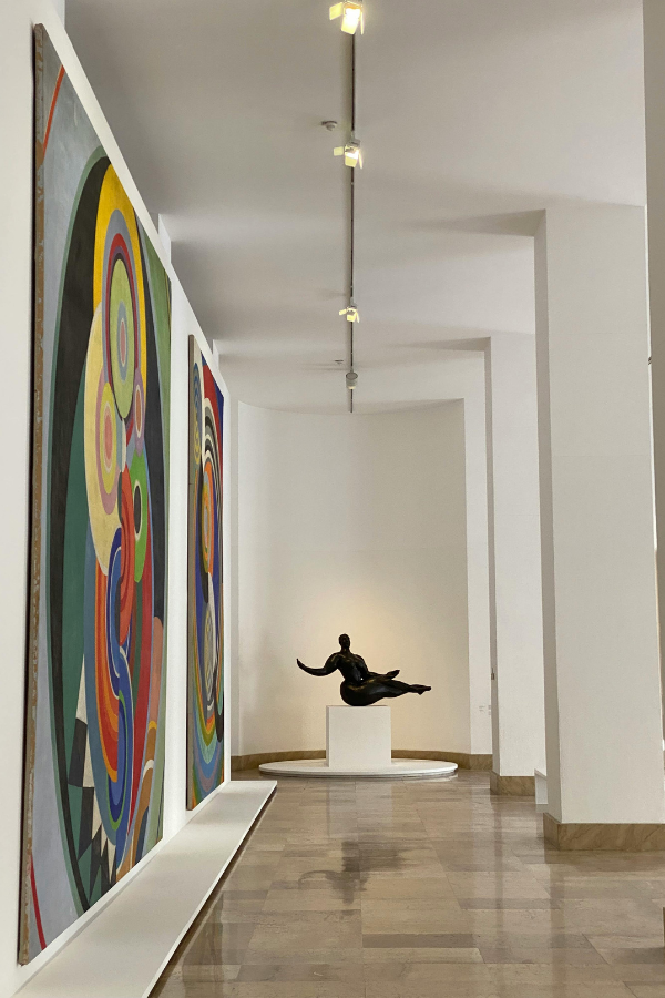 paintings and sculpture in a gallery