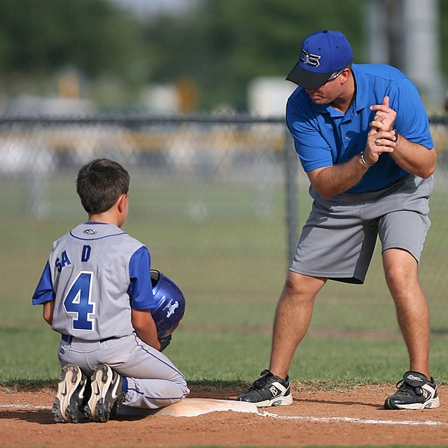 youth baseball coach, coaching his trael baseball player