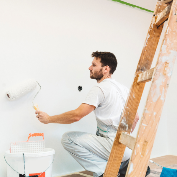 An image showing a professional painter working on a rental property.