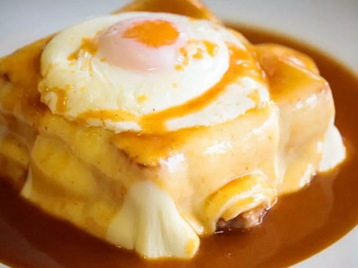 The famous Francesinha sandwich topped with an egg.