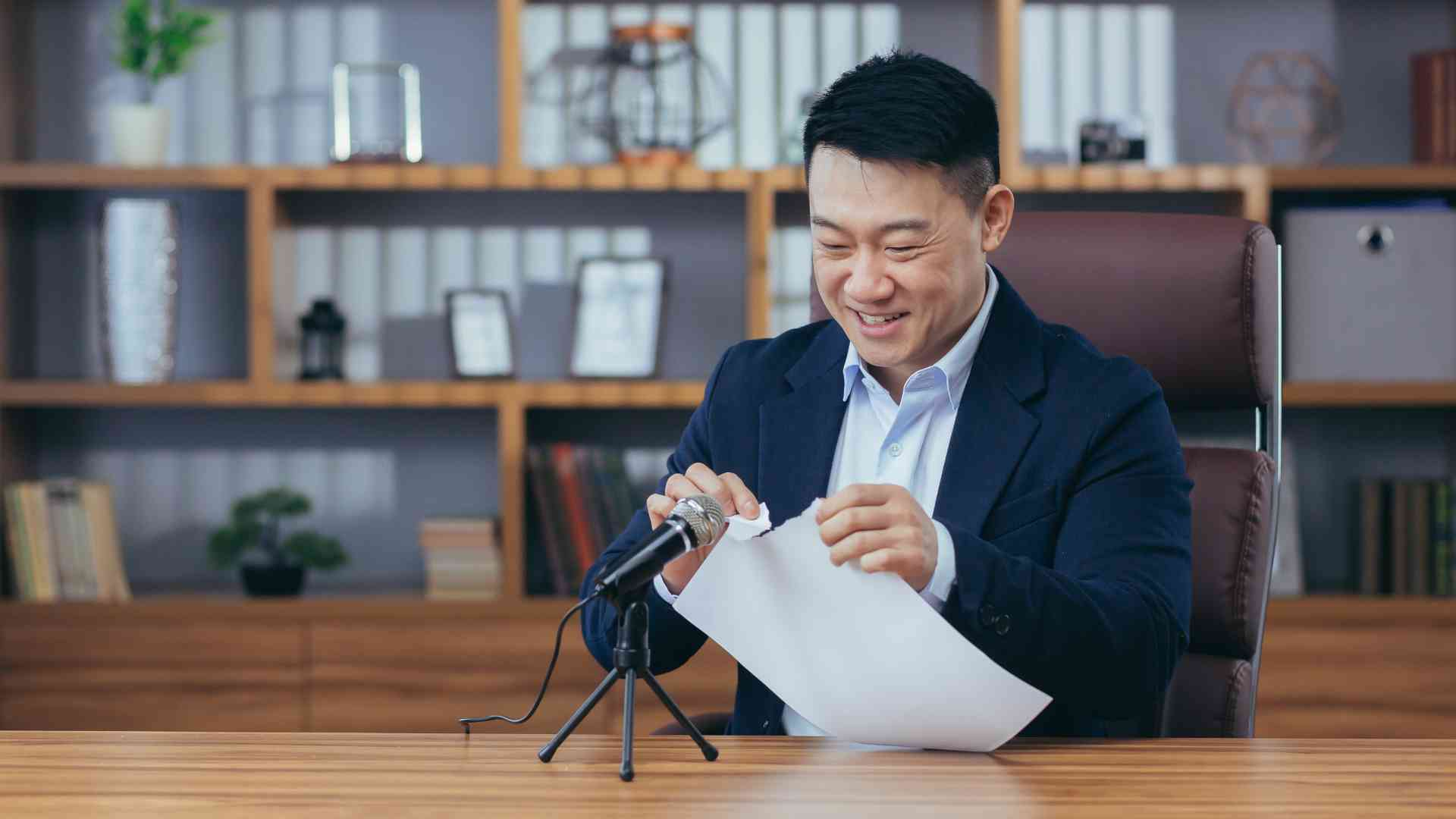 Man tearing paper near mic