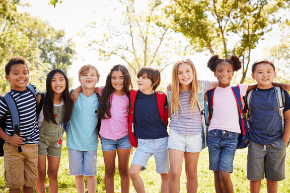 group of children smiling arms over each others shoulders