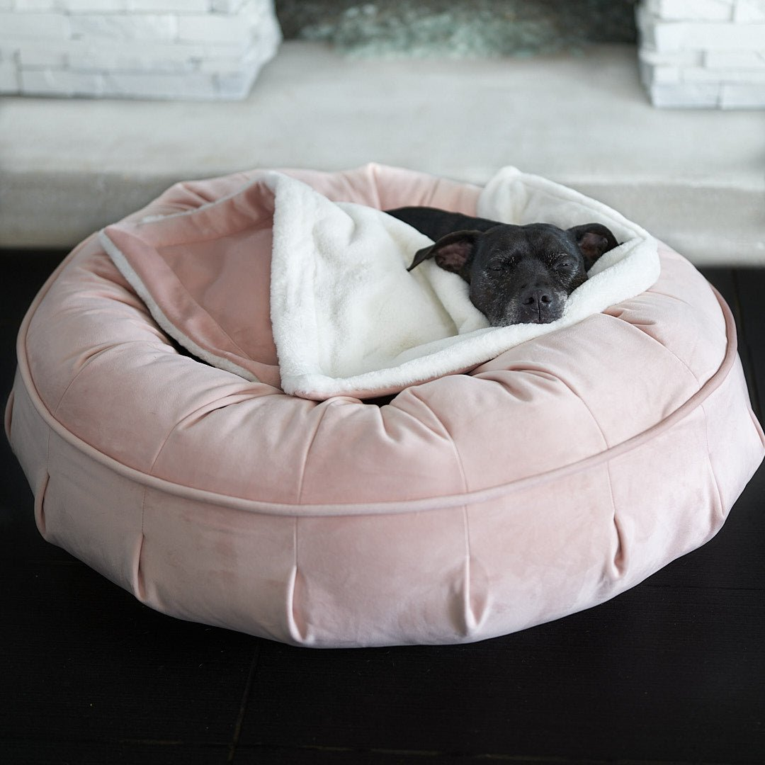 Pearl enjoying her luxurious dog bed, the pink Ali Jewel Puff Calming Dog Bed and a link to purchase.