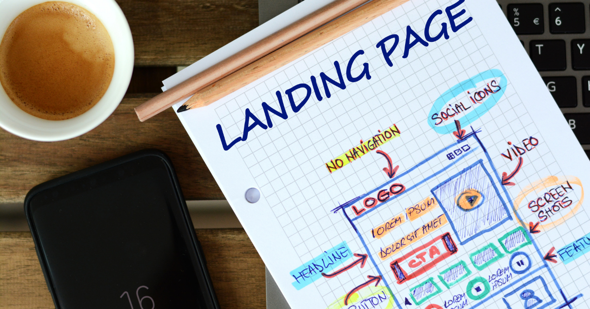 A cup of coffee sitting next to a notepad with the schematics for a new dental practice landing page.