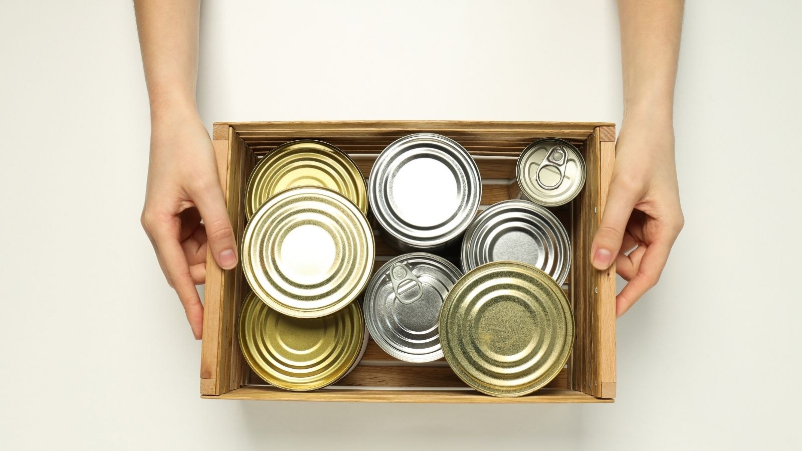 Wooden box filled with assorted sealed canned tuna containers