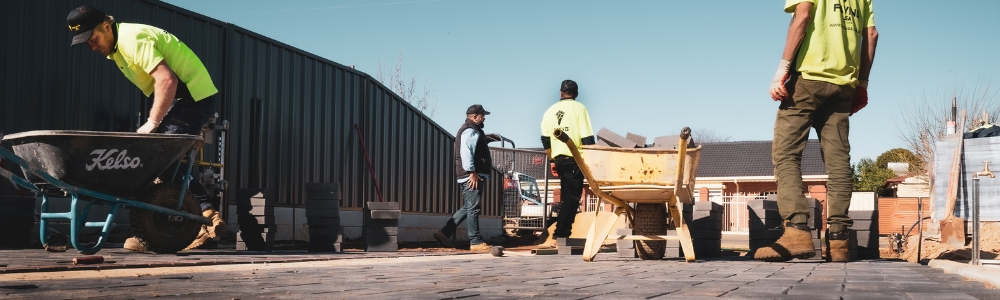 An image showing a paving contractor laying asphalt on a driveway, demonstrating what is a paving contractor.