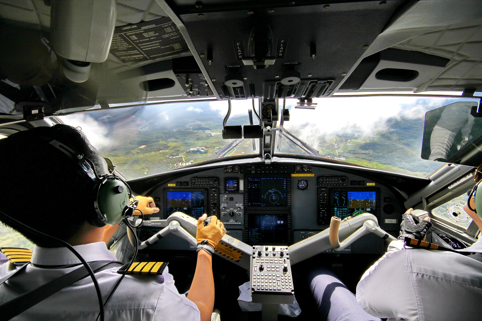Two pilots with high airline pilot ranks landing an airplane.