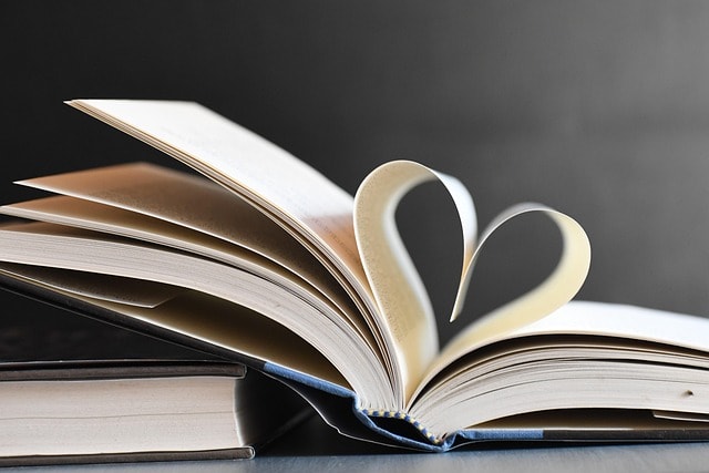 A book with its pages folded to create a heart, representing creative storytelling in writing on social media.