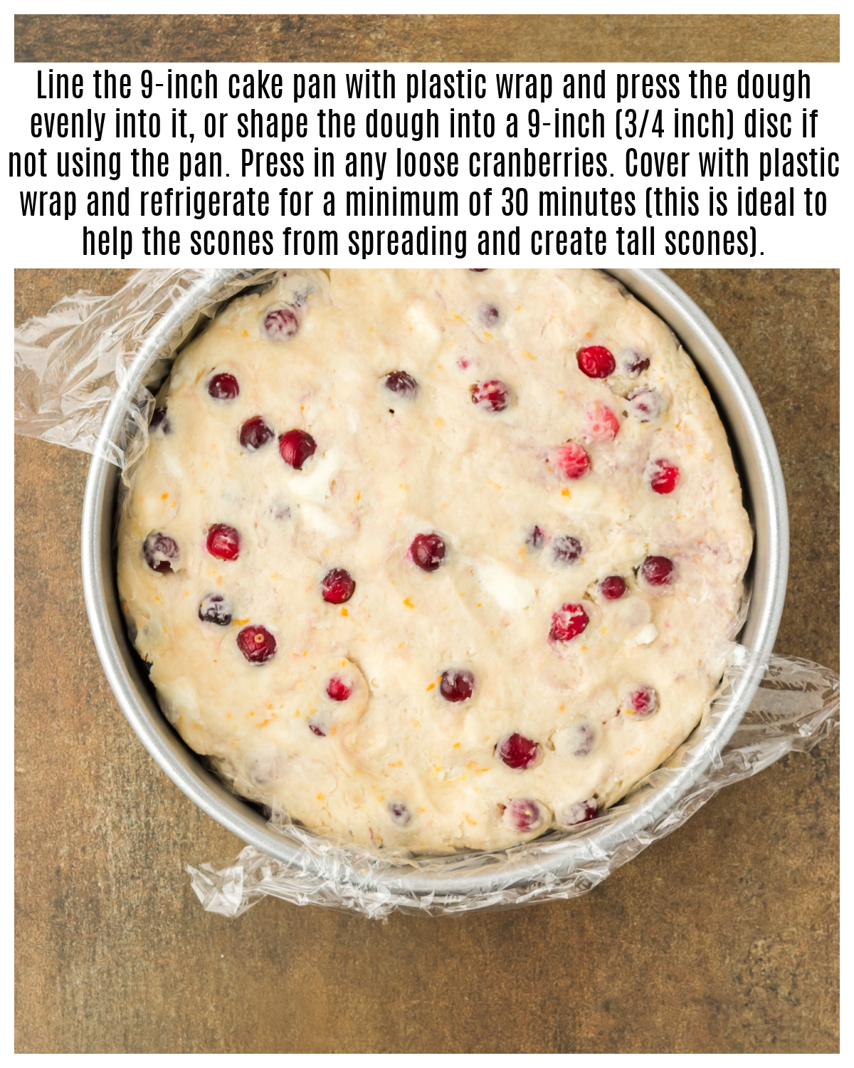 cranberry orange scone dough pressed into cake pan lined with plastic wrap