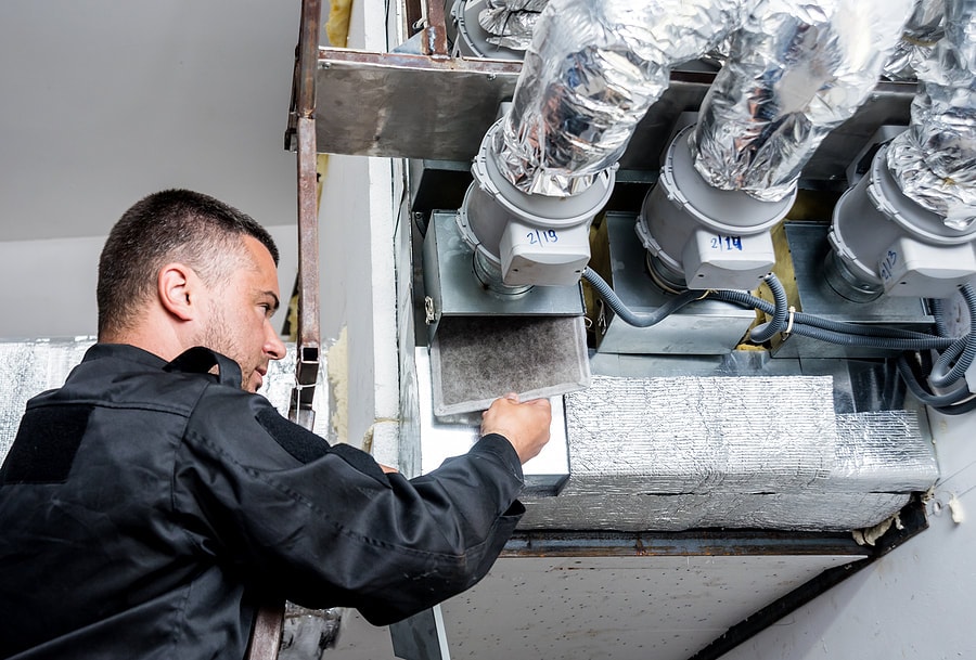 a tech looking at a recent ductwork installation